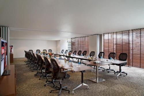 a conference room with a long table and chairs at Oakwood Residence Whitefield Bangalore in Bengaluru