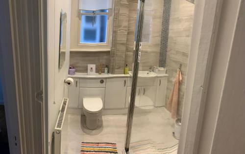 a bathroom with a shower and a toilet and a sink at Enliven in Broadstairs