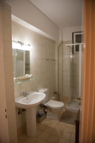 a bathroom with a sink and a toilet and a shower at Marias BBQ Garden House in Kalamata