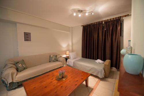 a living room with a couch and a coffee table at Marias BBQ Garden House in Kalamata