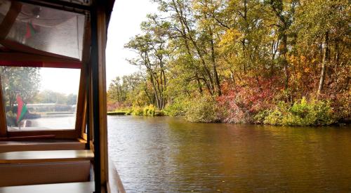 a boat on a river looking out a window at Boutique Hotel Chariot - Amsterdam Schiphol Airport in Aalsmeer