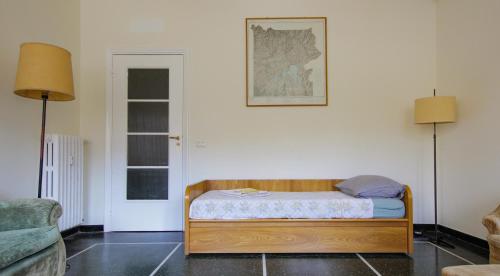 a room with a small bed and two lamps at Naima 32 in Genoa
