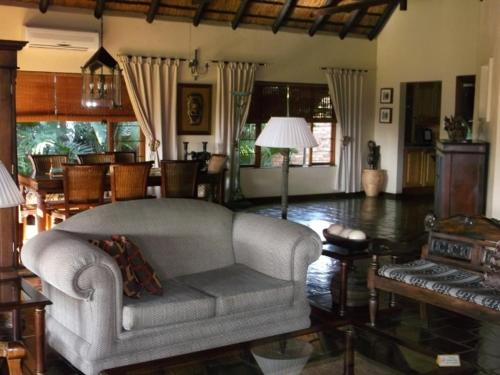 a living room with a couch and a table at Khandizwe Kruger Villa in Malelane