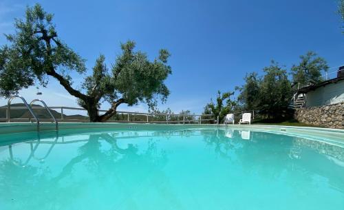 a large swimming pool with blue water at I Giardini Di Margius in Itri