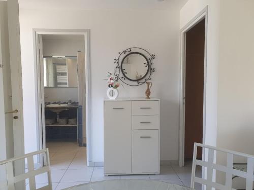 a room with a white dresser and a mirror at LES ALGUES T2 in Cannes