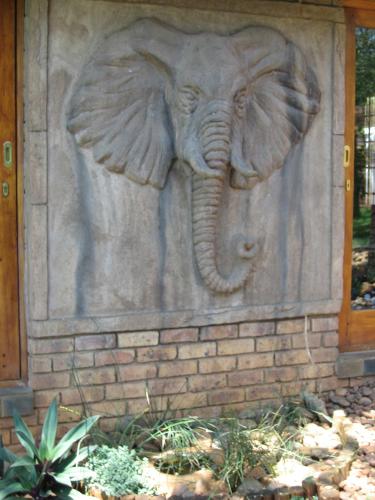 a statue of an elephant on the side of a building at Khandizwe Kruger Villa in Malelane