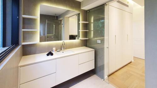 a bathroom with a sink and a mirror at BnBIsrael apartments - Dizengoff Brique in Tel Aviv