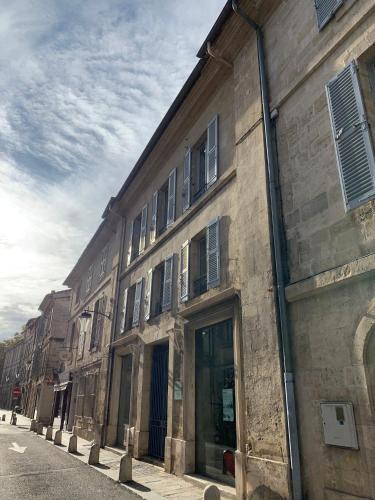 an old brick building with windows on a street at Apartment Limas in Avignon