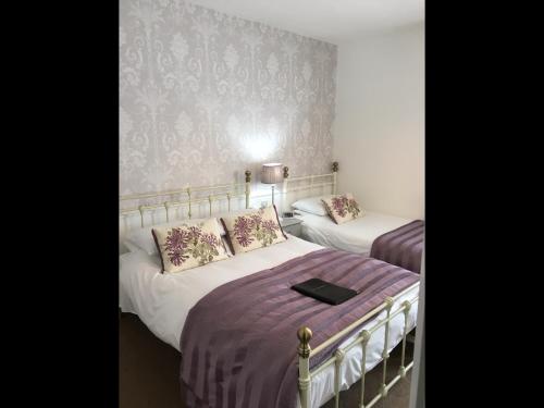 A bed or beds in a room at The Moorfield Hotel-Bed and Breakfast 