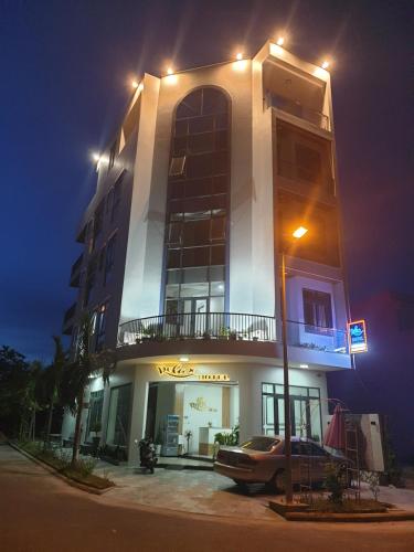 a building with a car parked in front of it at night at Relax hotel in Quy Nhon