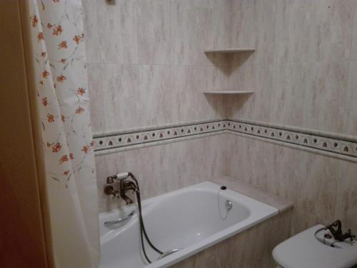 a bathroom with a bath tub and a sink at ALQUILER CASA PEPA EN CAZORLA in Cazorla