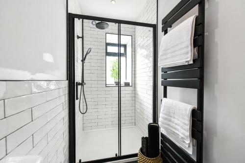 a shower with a glass door in a bathroom at South Shores Cottage Flat in Troon