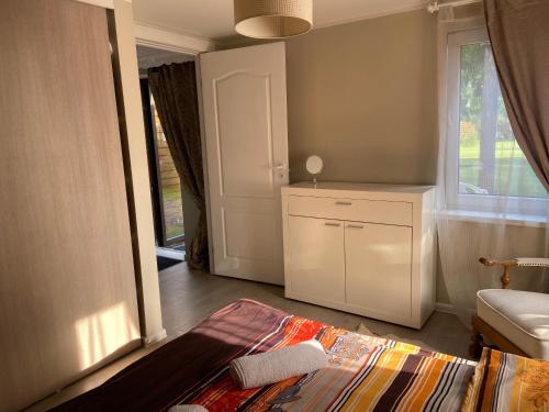 a room with a bathroom with a window and a rug at Cosy and peaceful apartment in Kaunas