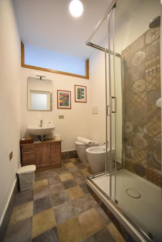 a bathroom with a shower and a toilet and a sink at B&B La Riundela in Asti