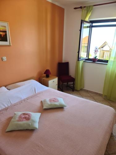 a bedroom with two towels on a bed with a window at Villa Antonio in Opatija