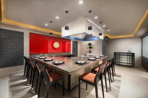 a large dining room with a large table and chairs at Bahi Ajman Palace Hotel in Ajman 