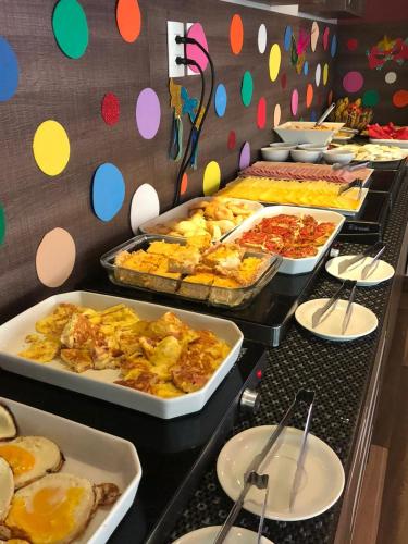 a buffet line with many different types of food at Pousada SUN Victory in Cabo Frio