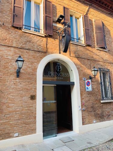a brick building with a entrance to a pharmacy at Princess Art Hotel in Ferrara