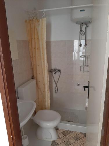 a bathroom with a toilet and a sink at Apartman Matea in Hvar