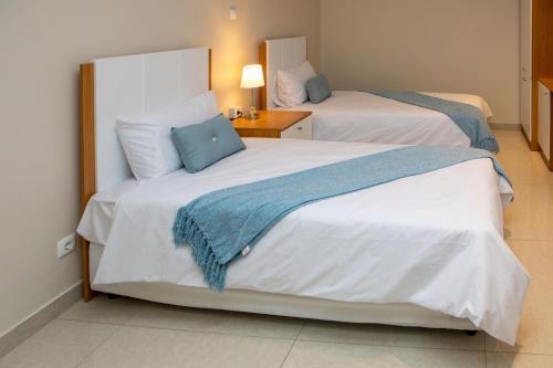 Una cama o camas en una habitación de Triunfo Guest House