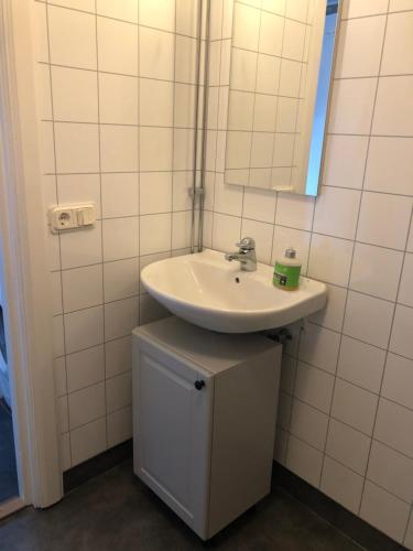 a bathroom with a sink and a mirror at Mormors vrå in Mora