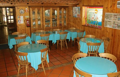 a dining room with blue tables and chairs at Hotel Joao Capela in Aveiro