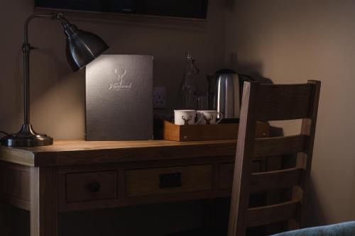 a desk with a box and a lamp on it at The Haughmond in Shrewsbury