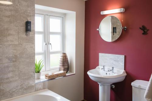 a bathroom with a sink and a mirror at The Haughmond in Shrewsbury