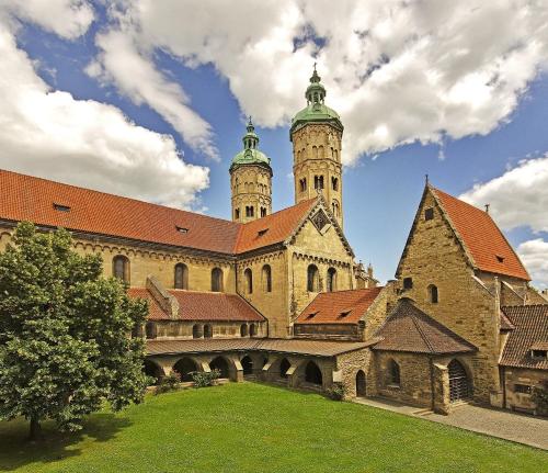 a large building with two towers on top of it at Pension Onkel Ernst in Naumburg
