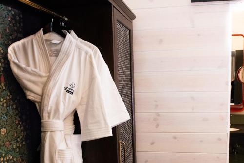 a white shirt hanging in a closet at Cotton Court Hotel, by Valencia Hotel Collection in Lubbock