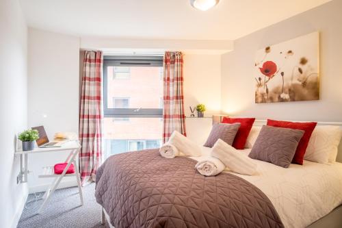 Schlafzimmer mit einem Bett, einem Schreibtisch und einem Fenster in der Unterkunft Stylish City 2 Bed, 2 Bath, FREE PARKING & WiFi in Sheffield