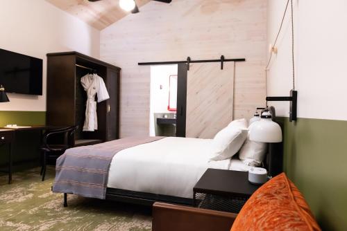 a hotel room with a bed and a desk and a room at Cotton Court Hotel, by Valencia Hotel Collection in Lubbock