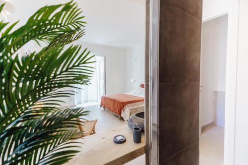 a bedroom with a bed and a palm tree at Break for two in Agropoli