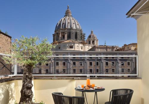 a table and chairs with a view of a building at Le Boutique Hotel in Rome