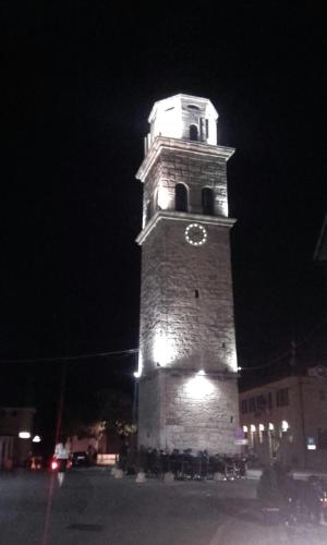 a tall tower with a clock on it at night at Casa Nonna Tereza in Premantura