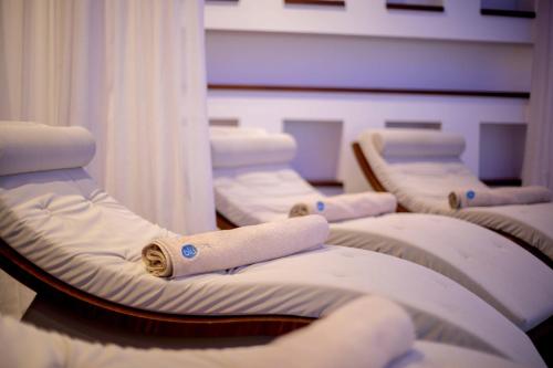 a row of hospital beds in a room with curtains at Tasia Maris Beach Hotel - Adults Only in Ayia Napa