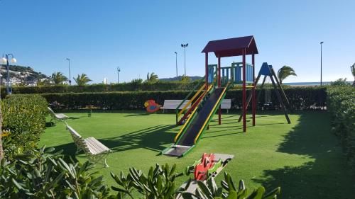 a playground with a slide in a park at A. Garganta - Rocamaura & Catalonia in L'Estartit