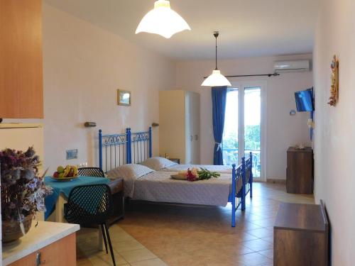 a bedroom with a bed and a table in a room at Akti Aegeou in Agios Sostis