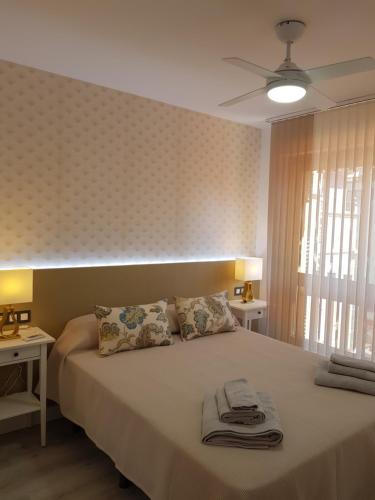 sypialnia z łóżkiem z ręcznikami w obiekcie Ordoño II Suites con Aire Acondicionado y Wifi w mieście León