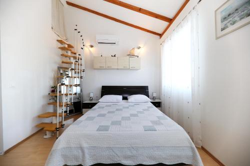 a bedroom with a bed and a book shelf at Puntamika studio in Zadar