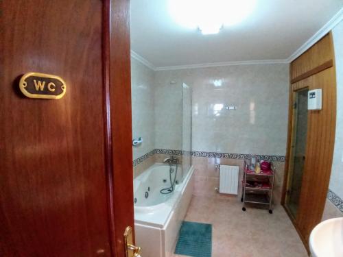 a bathroom with a bath tub and a sink at Laredo Ocean Port in Laredo