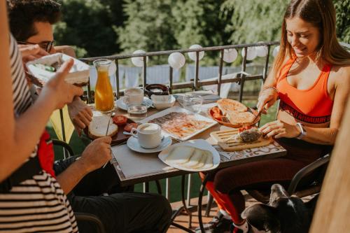 a group of people sitting around a table eating food at Casa Etxalde in Camprodon