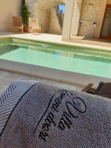 a towel sitting next to a swimming pool at Villa Kameni dvori in Sveti Filip i Jakov