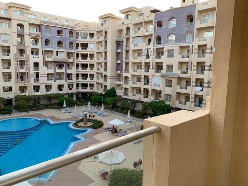 a view of a large apartment building with a swimming pool at Florenza Khamsin 1 bedroom apartment with swimming pool view in Hurghada