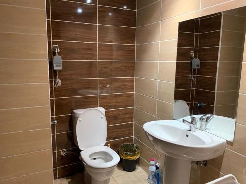 a bathroom with a toilet and a sink at Florenza Khamsin 1 bedroom apartment with swimming pool view in Hurghada