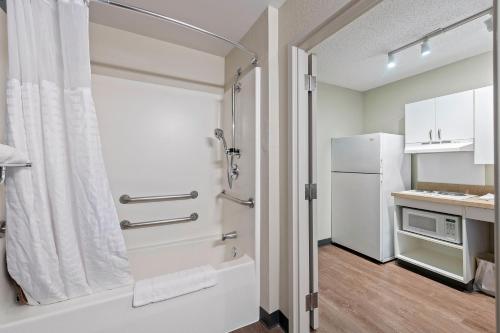 a small kitchen with a shower and a refrigerator at Extended Stay America Premier Suites - Oakland - Alameda in Alameda