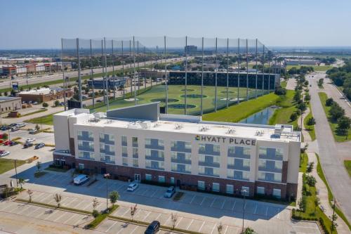 an aerial view of an apartment building with a parking lot at Hyatt Place Dallas/The Colony in The Colony