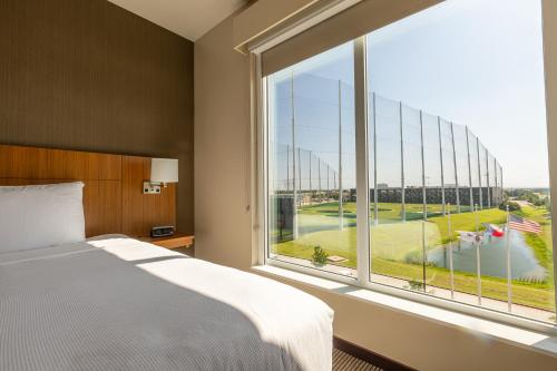 a bedroom with a bed and a large window at Hyatt Place Dallas/The Colony in The Colony