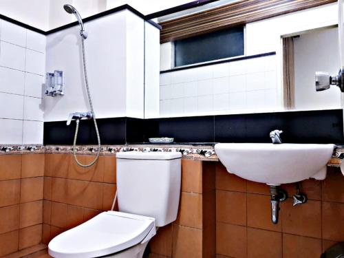 a bathroom with a toilet and a sink at Hotel Setrasari Bandung in Bandung