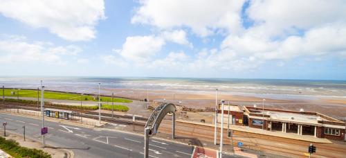 a view of a road with the beach and the ocean at Burbage Holiday Lodge Apartment 5 in Blackpool